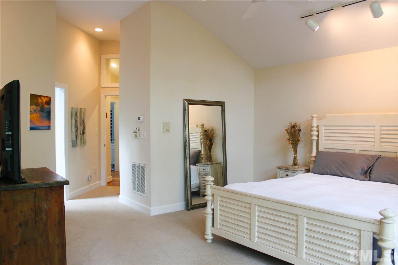 505 Booth Road Chapel Hill, NC 27516 - Photo 11 of 25 a bedroom with a bed and a flat screen tv