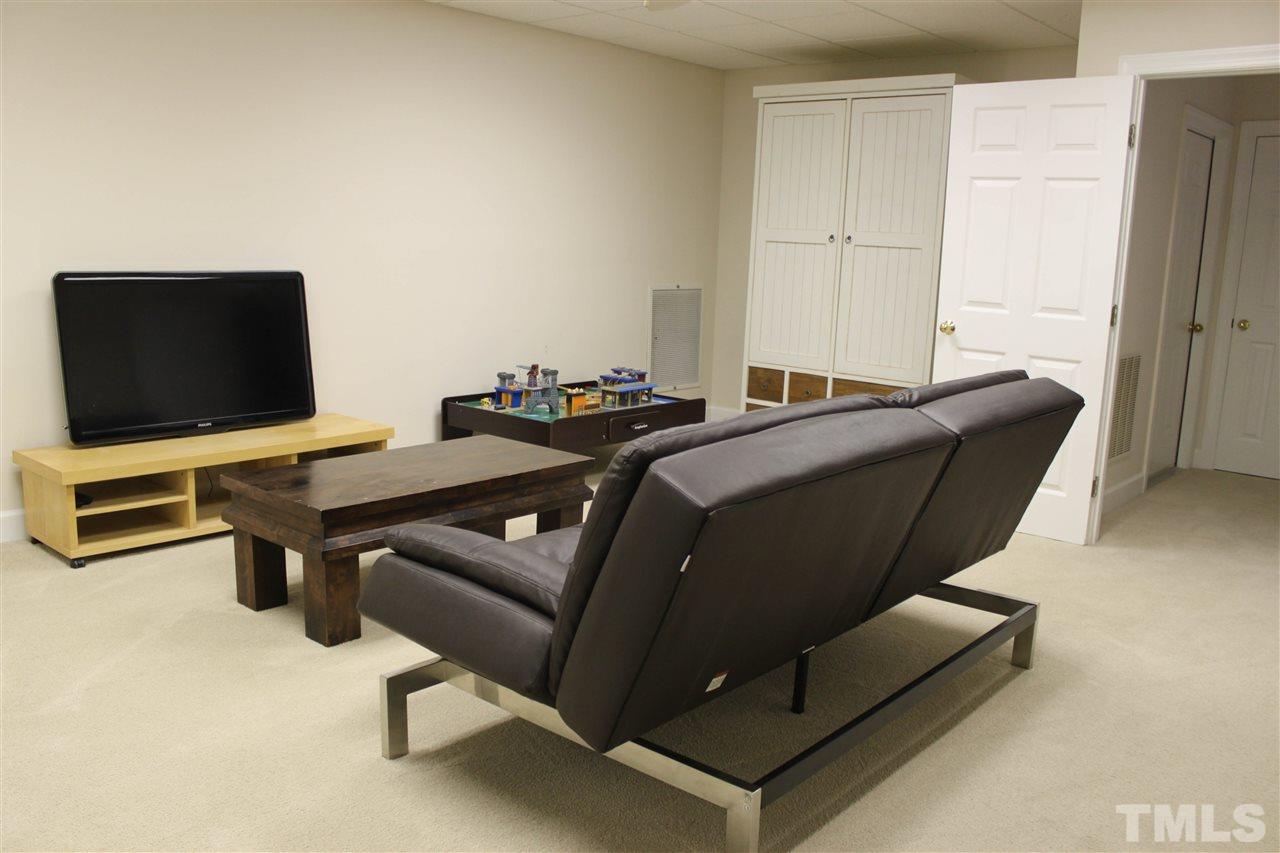 505 Booth Road Chapel Hill, NC 27516 - Photo 13 of 25 a living room with furniture and a flat screen tv
