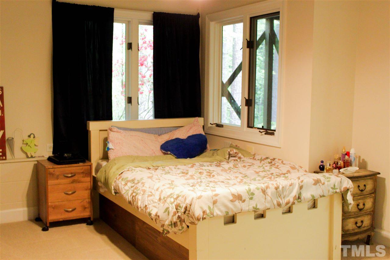 505 Booth Road Chapel Hill, NC 27516 - Photo 14 of 25 a bed sitting in a bedroom next to a window