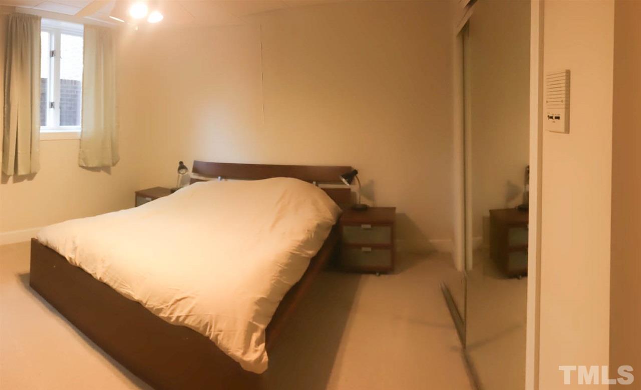 505 Booth Road Chapel Hill, NC 27516 - Photo 16 of 25 a bed sitting in a bedroom next to a window