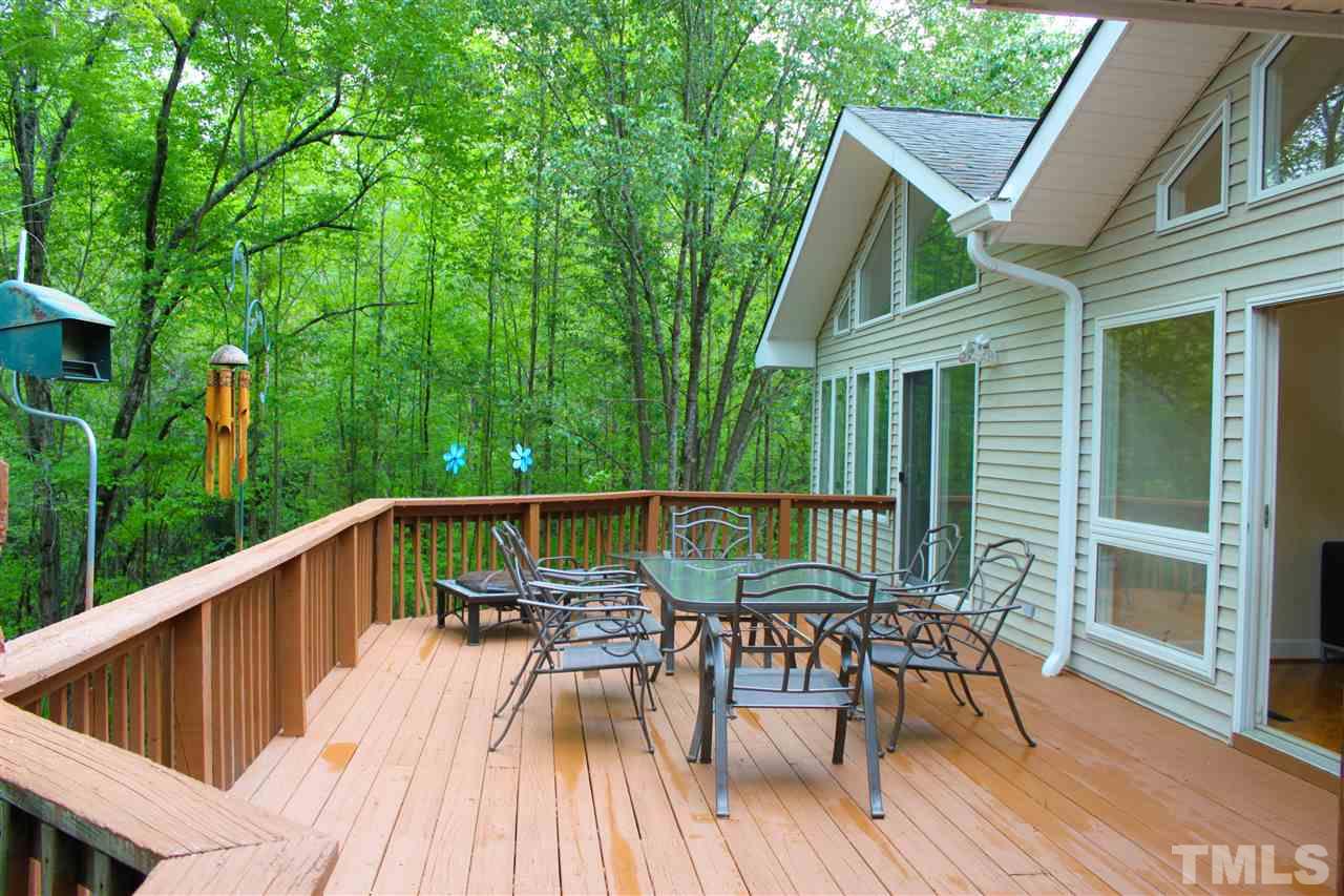 505 Booth Road Chapel Hill, NC 27516 - Photo 20 of 25 a view of a patio with table and chairs with wooden floor and fence