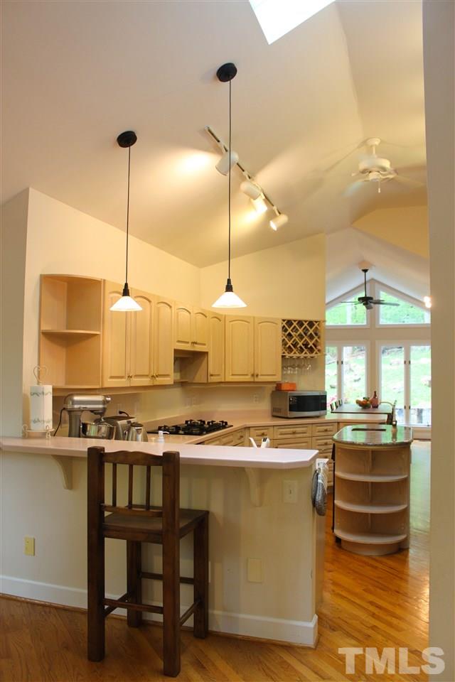 505 Booth Road Chapel Hill, NC 27516 - Photo 3 of 25 a kitchen with stainless steel appliances granite countertop a stove a sink island and a refrigerator