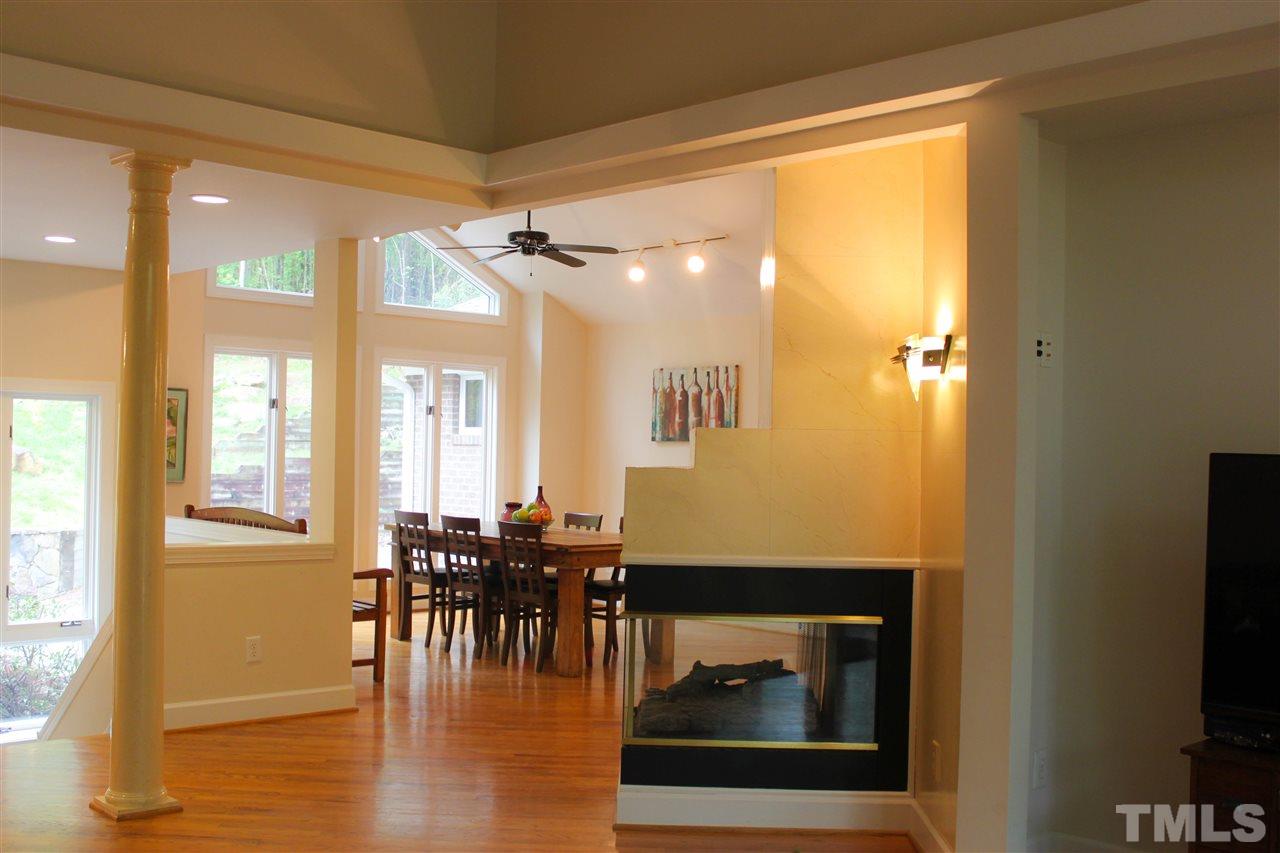 505 Booth Road Chapel Hill, NC 27516 - Photo 8 of 25 a dining room with wooden floor a glass table and chairs