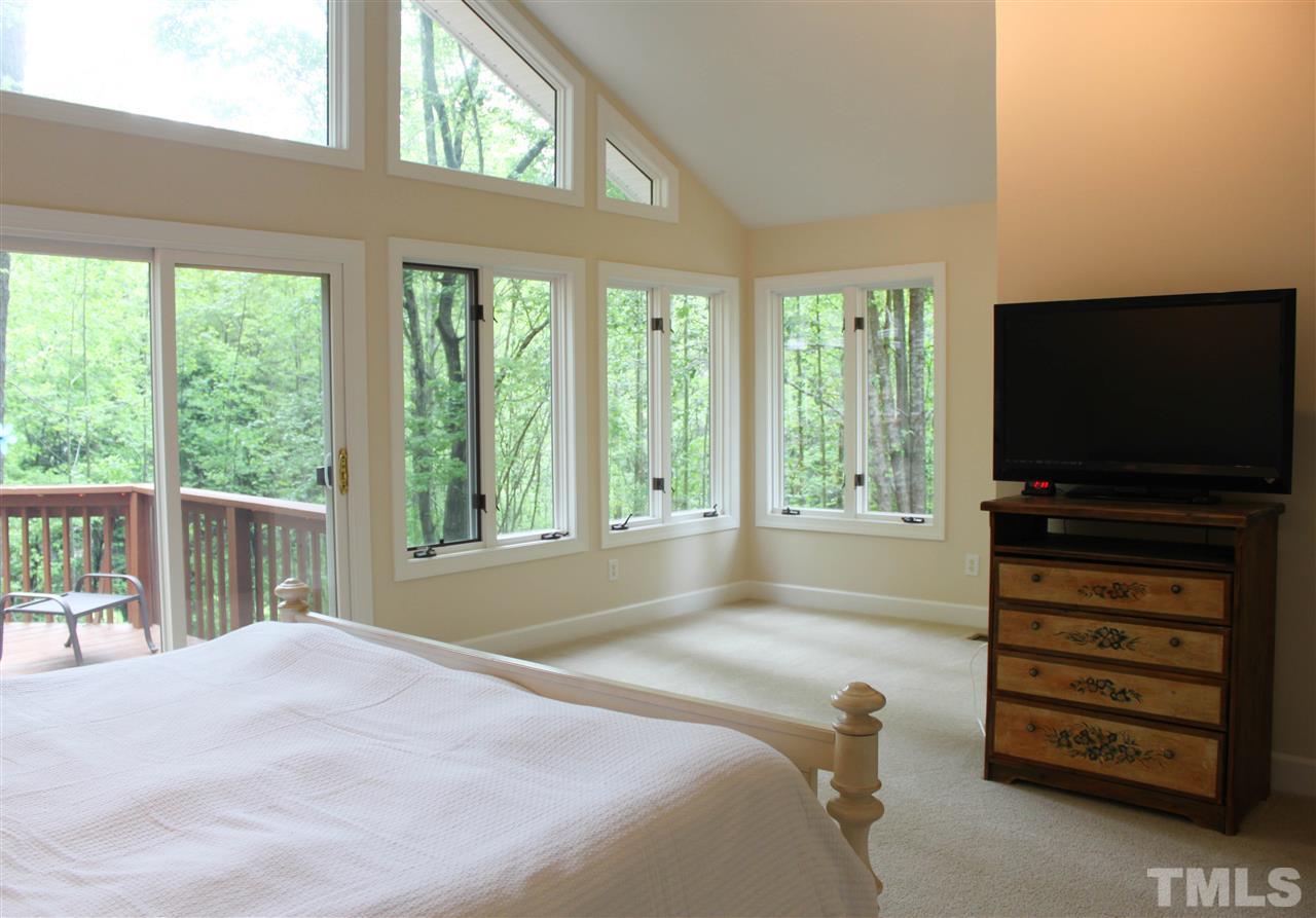 505 Booth Road Chapel Hill, NC 27516 - Photo 9 of 25 a bedroom with a bed and a flat screen tv