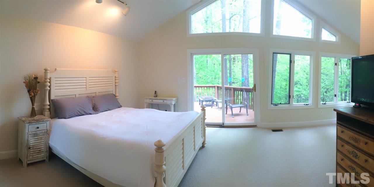 505 Booth Road Chapel Hill, NC 27516 - Photo 10 of 25 a bedroom with a bed and a large window