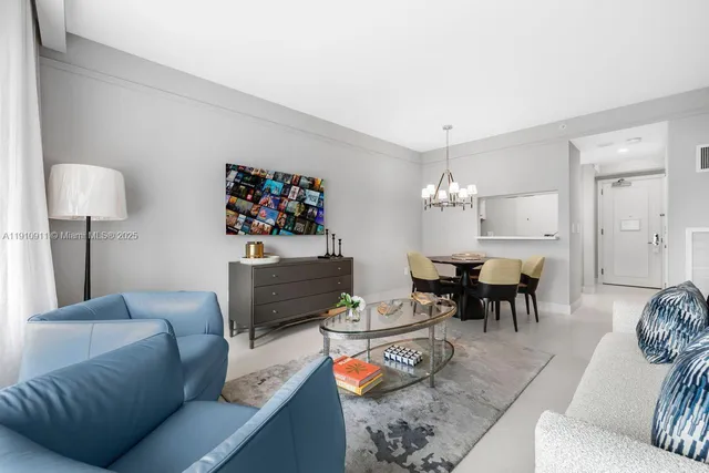 a living room with furniture and a dining table with wooden floor