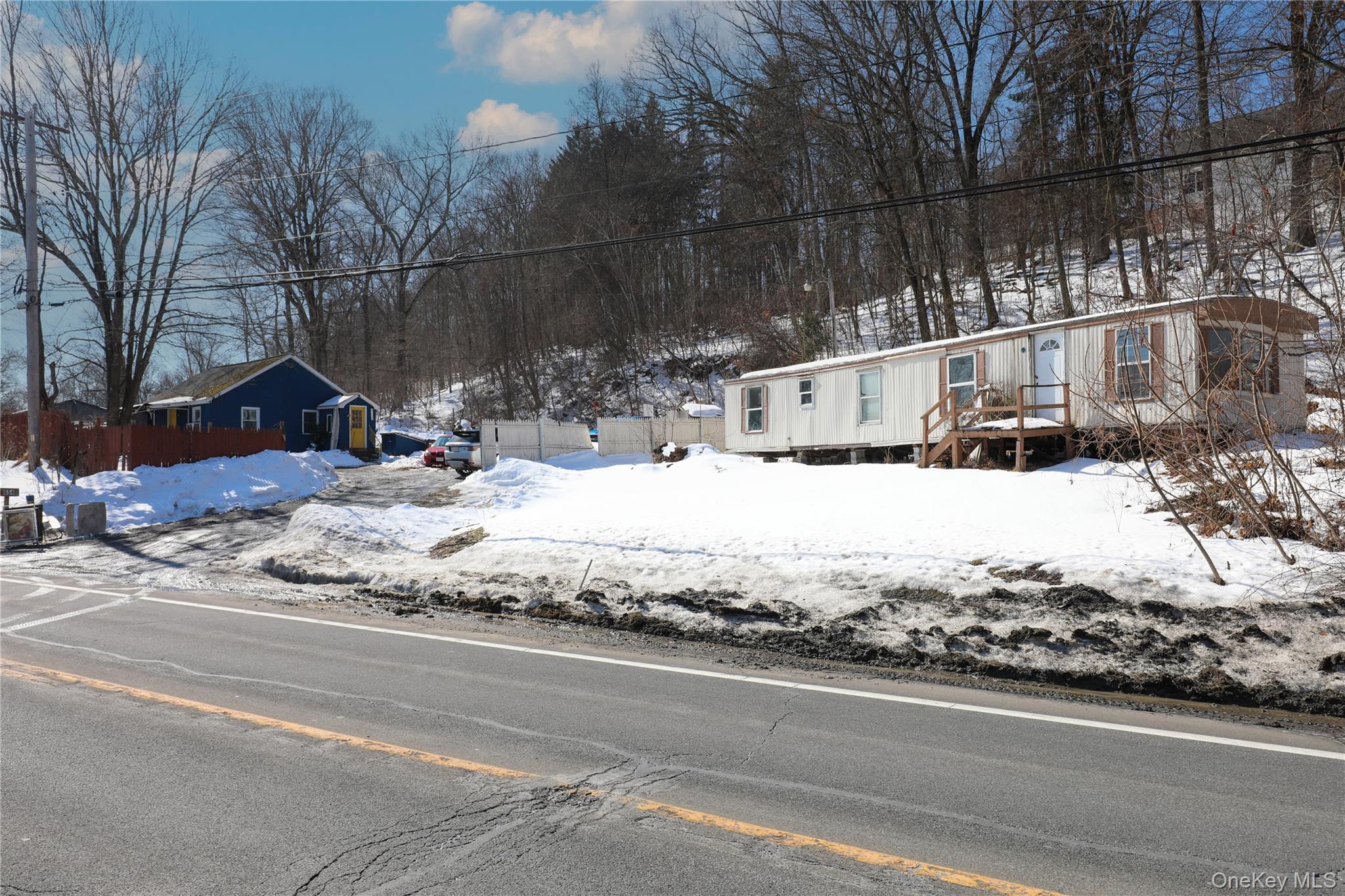 a view of a house with snow on the road