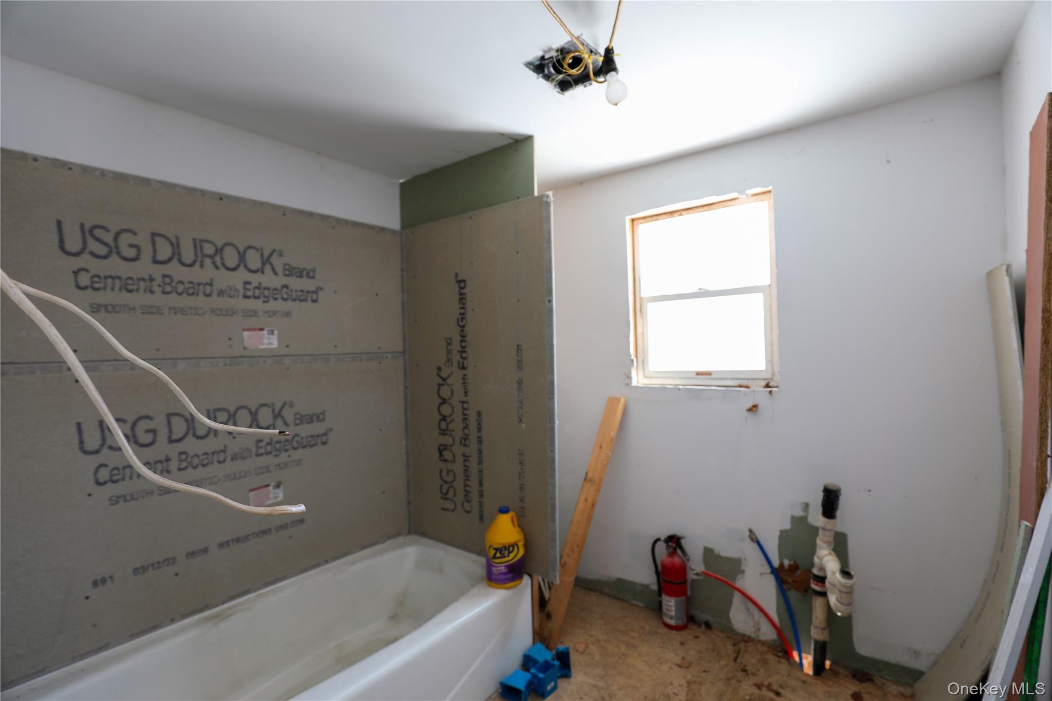 654 Broadway, Unit 9W Esopus, NY 12487 - Photo 25 of 26 a bathroom with a bathtub a sink and a window
