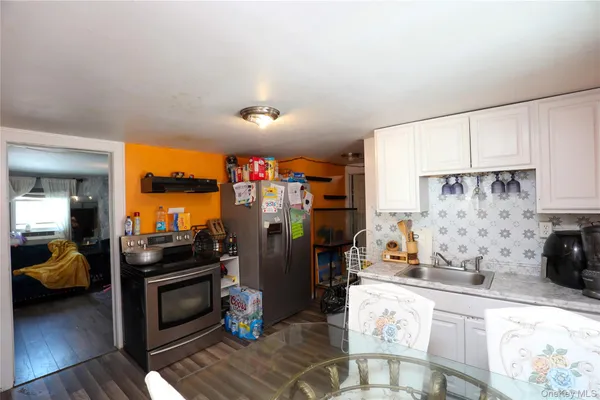 a kitchen with stainless steel appliances kitchen island granite countertop a refrigerator stove and sink