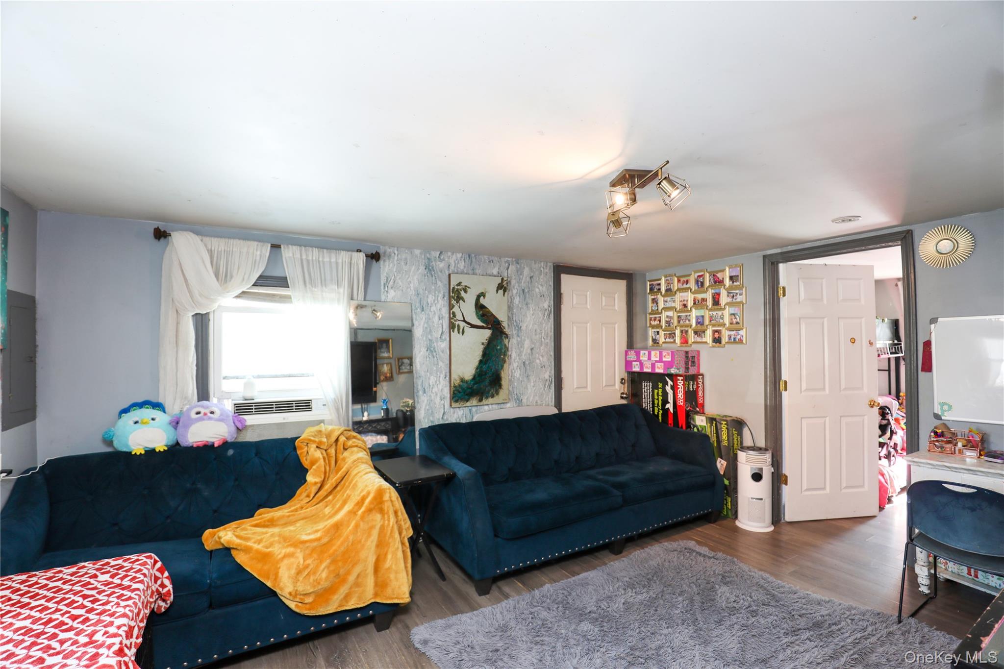 654 Broadway, Unit 9W Esopus, NY 12487 - Photo 9 of 26 a living room with furniture and a window