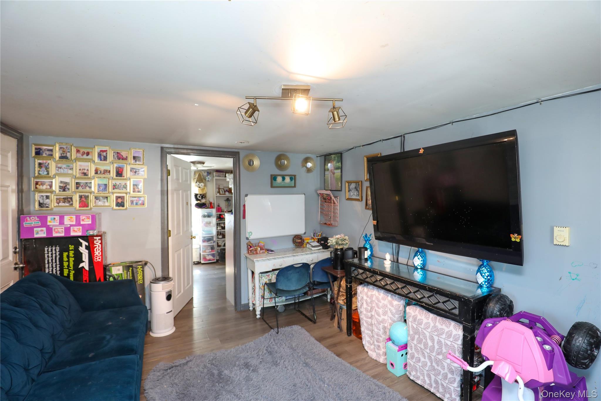 654 Broadway, Unit 9W Esopus, NY 12487 - Photo 10 of 26 a living room with furniture and a flat screen tv