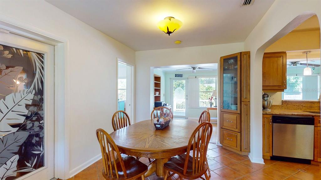 1618 Tuscola Road Clearwater, FL 33756 - Photo 16 of 64 a view of a dining room with furniture and wooden floor