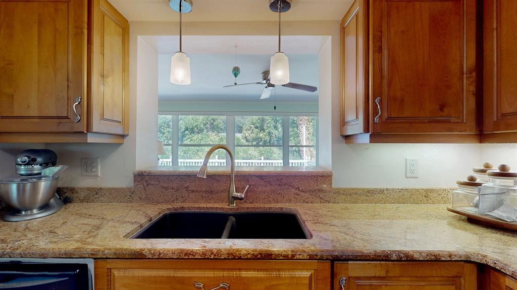 1618 Tuscola Road Clearwater, FL 33756 - Photo 17 of 64 a kitchen with granite countertop a sink and a stove