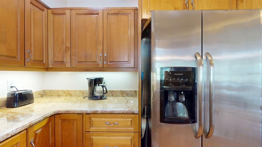 1618 Tuscola Road Clearwater, FL 33756 - Photo 18 of 64 a kitchen with a refrigerator and cabinets