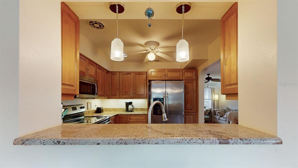 1618 Tuscola Road Clearwater, FL 33756 - Photo 19 of 64 a kitchen with stainless steel appliances granite countertop a sink and a stove