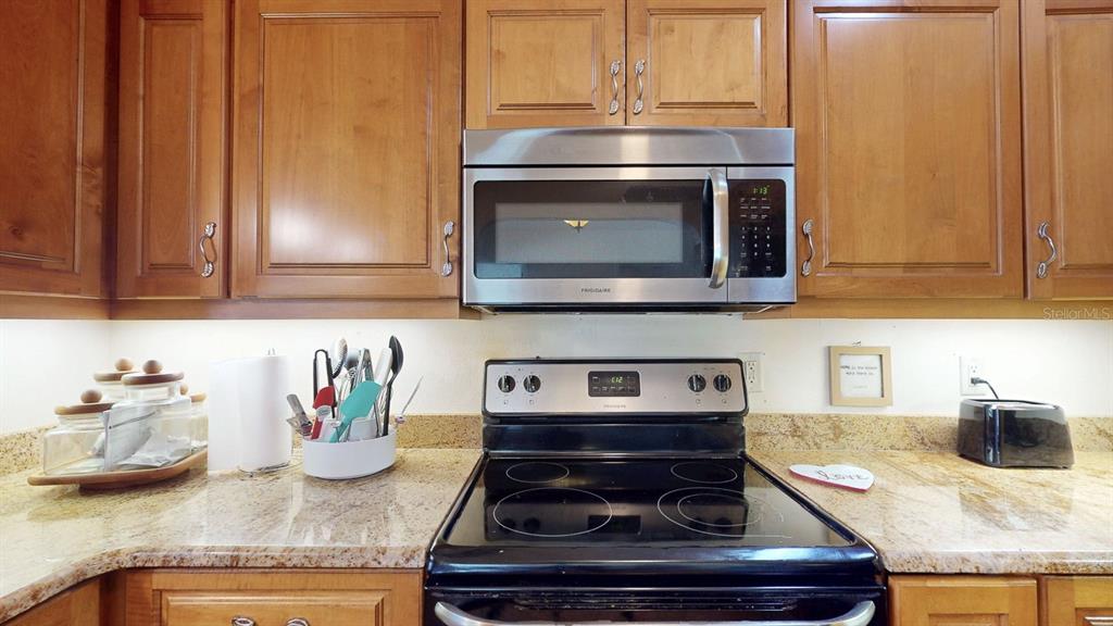 1618 Tuscola Road Clearwater, FL 33756 - Photo 20 of 64 a kitchen with granite countertop stainless steel appliances and cabinets