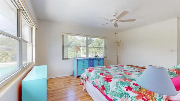 a bedroom with a bed a window and a chandelier