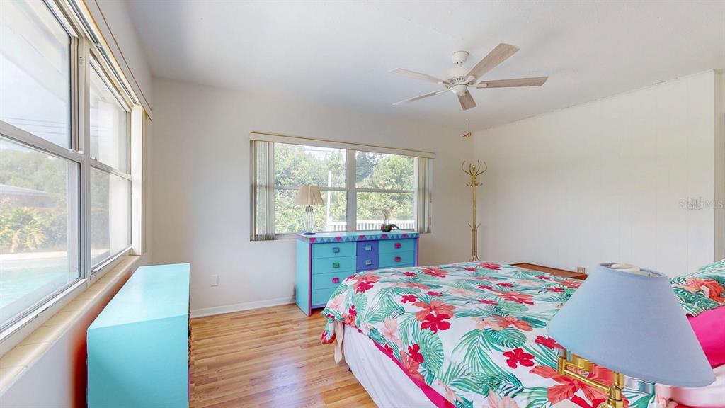 1618 Tuscola Road Clearwater, FL 33756 - Photo 22 of 64 a bedroom with a bed and a large window