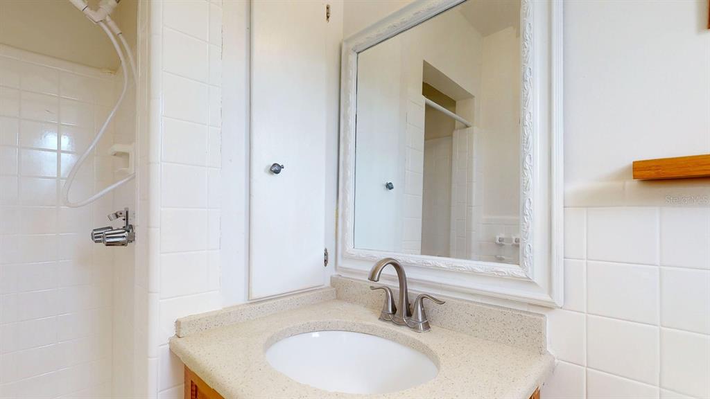 1618 Tuscola Road Clearwater, FL 33756 - Photo 29 of 64 a bathroom with a sink and a mirror