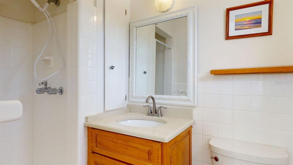1618 Tuscola Road Clearwater, FL 33756 - Photo 33 of 64 a bathroom with a sink toilet and vanity