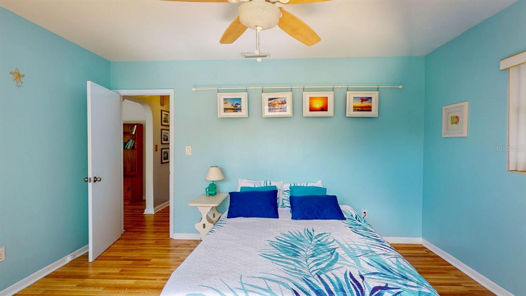 1618 Tuscola Road Clearwater, FL 33756 - Photo 36 of 64 a bedroom with a bed and wooden floor