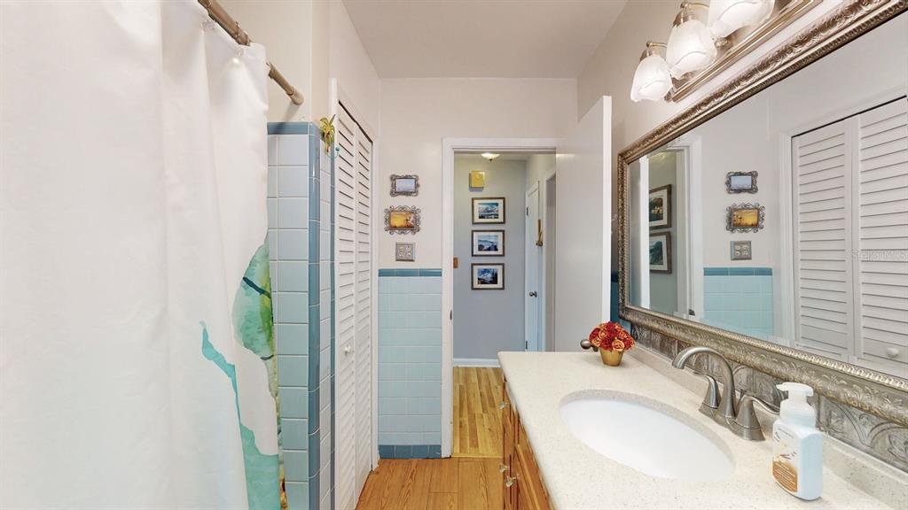 1618 Tuscola Road Clearwater, FL 33756 - Photo 39 of 64 a bathroom with a sink vanity granite and a mirror