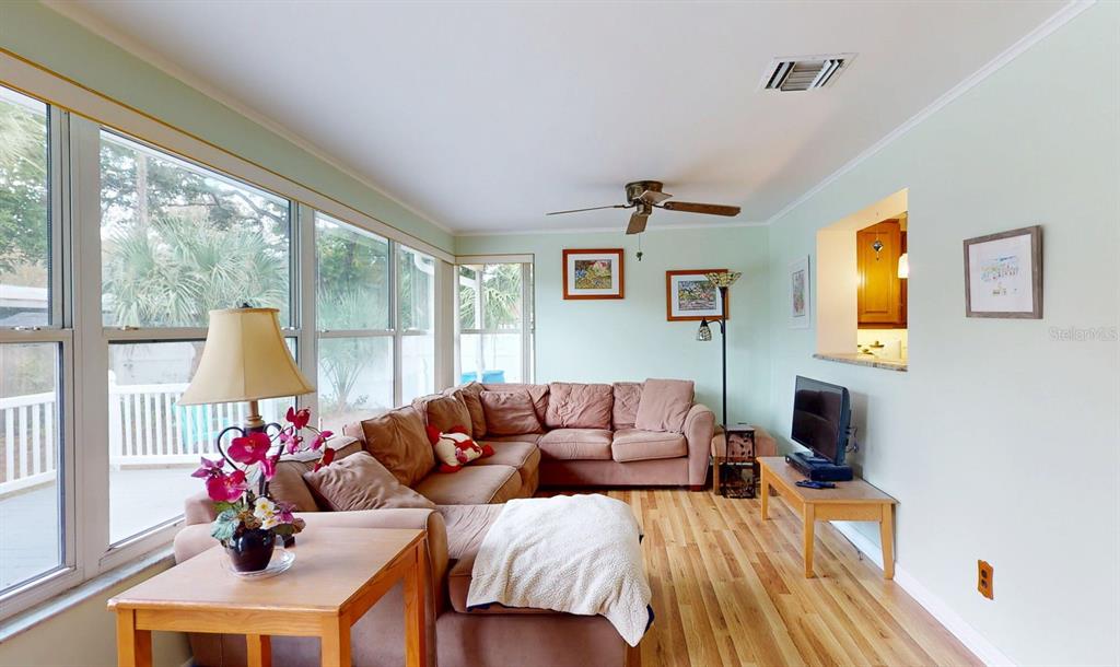 1618 Tuscola Road Clearwater, FL 33756 - Photo 48 of 64 a living room with furniture and a flat screen tv
