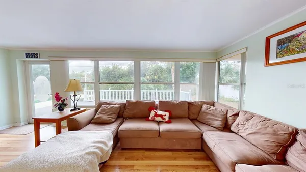 a living room with furniture and a book shelf