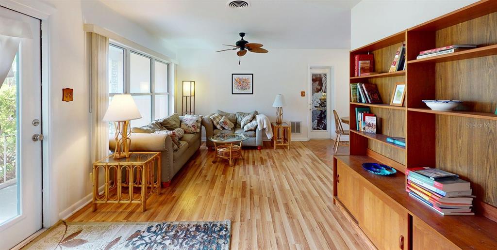 1618 Tuscola Road Clearwater, FL 33756 - Photo 9 of 64 a living room with furniture and a book shelf