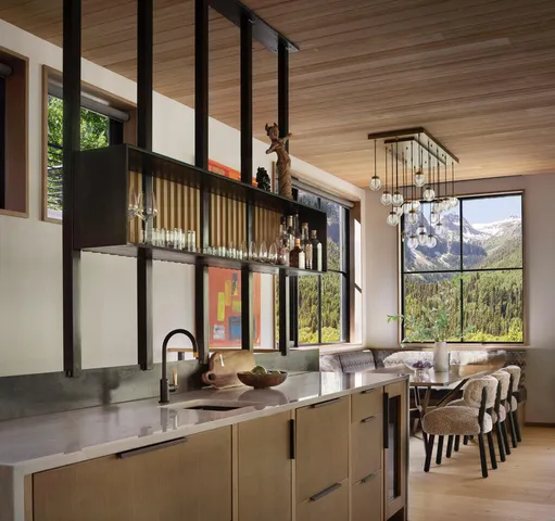 a kitchen with a table chairs sink and cabinets