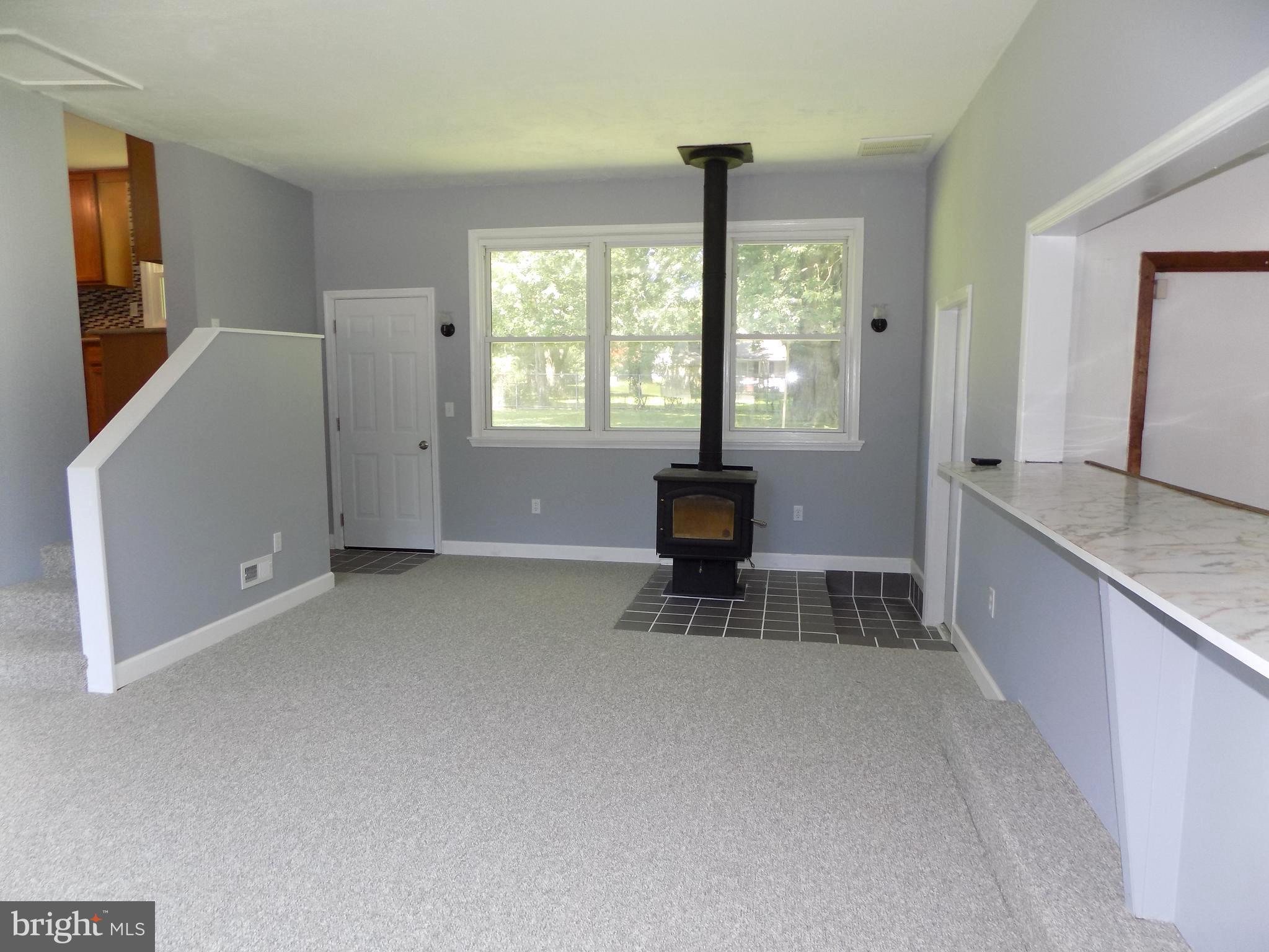 620 Romancoke Road Stevensville, MD 21666 - Photo 23 of 47 Bar and woodstove highlight the bonus room.