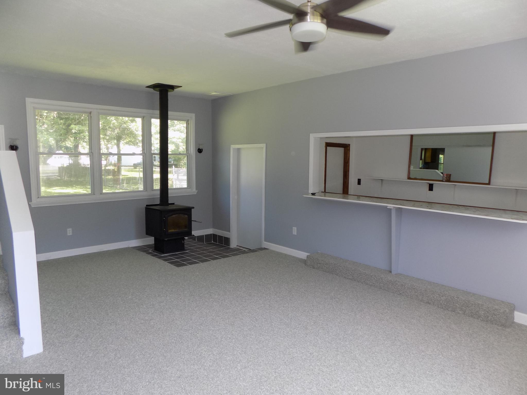 620 Romancoke Road Stevensville, MD 21666 - Photo 24 of 47 Bar and woodstove highlight the bonus room.