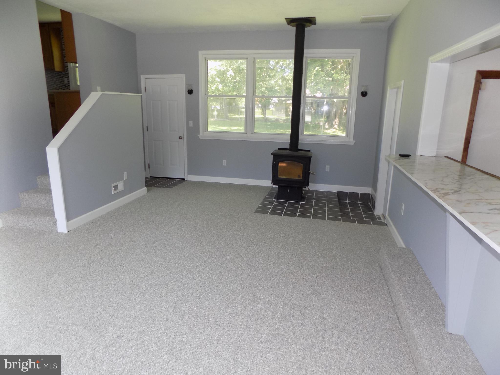 620 Romancoke Road Stevensville, MD 21666 - Photo 27 of 47 Bar and woodstove highlight the bonus room.