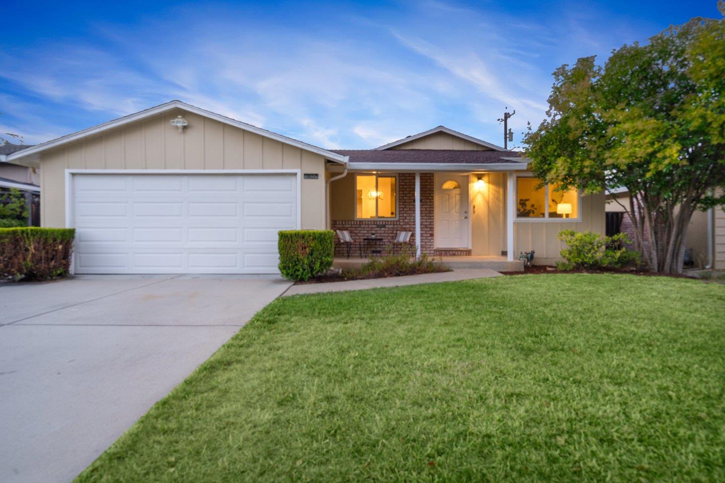 7457 Rollingdell Drive Cupertino, CA 95014 - Photo 1 of 33 a front view of a house with a yard and garage