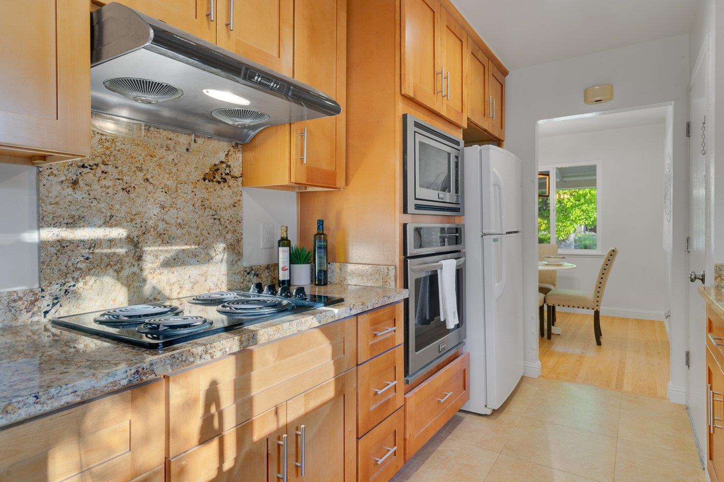 7457 Rollingdell Drive Cupertino, CA 95014 - Photo 13 of 33 a kitchen with stainless steel appliances granite countertop a sink stove and refrigerator