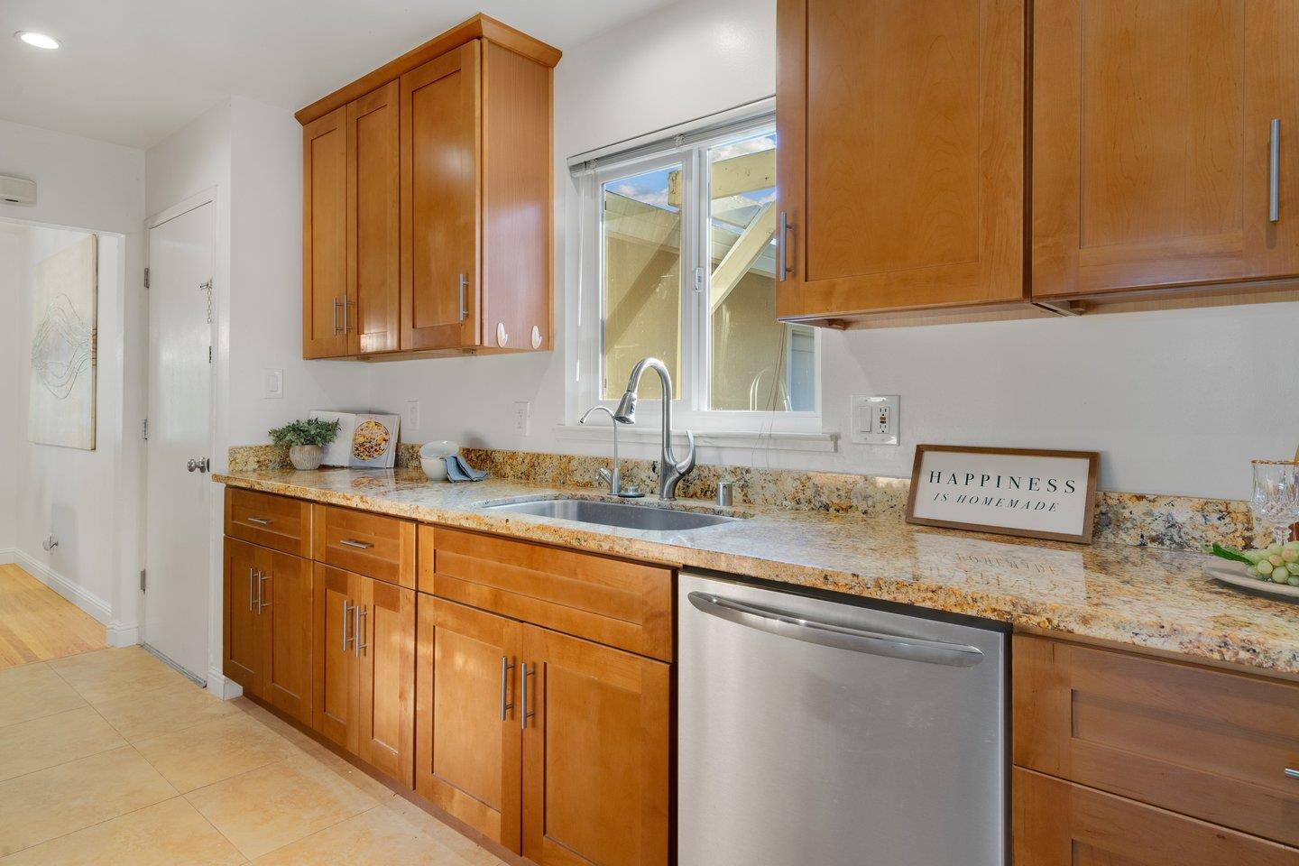 7457 Rollingdell Drive Cupertino, CA 95014 - Photo 14 of 33 a kitchen with stainless steel appliances granite countertop a sink stove and cabinets