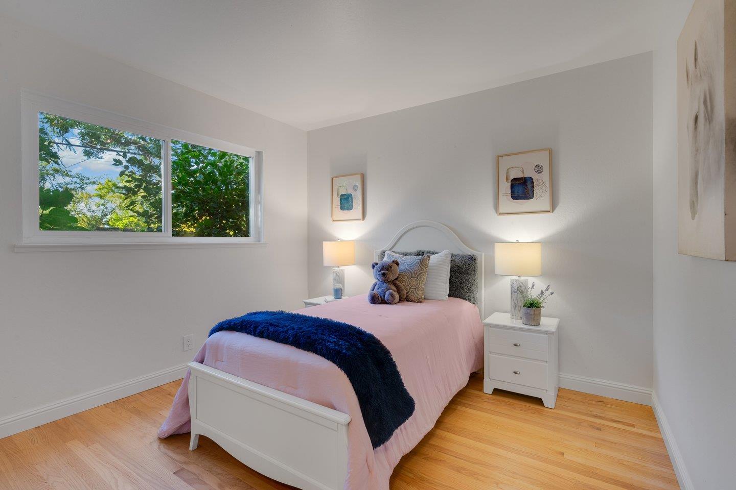 7457 Rollingdell Drive Cupertino, CA 95014 - Photo 21 of 33 a bedroom with a bed lamp and a window