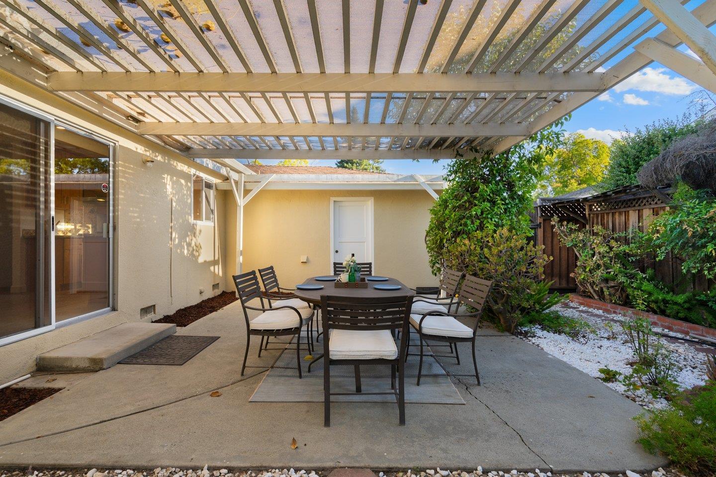 7457 Rollingdell Drive Cupertino, CA 95014 - Photo 27 of 33 a view of a patio with table and chairs and potted plants
