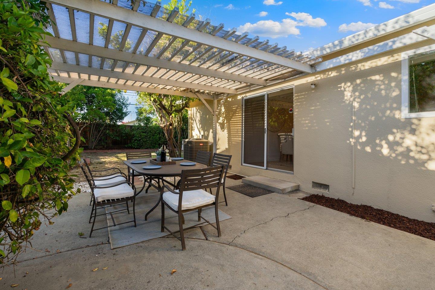 7457 Rollingdell Drive Cupertino, CA 95014 - Photo 28 of 33 a view of a patio with a table and chairs and potted plants