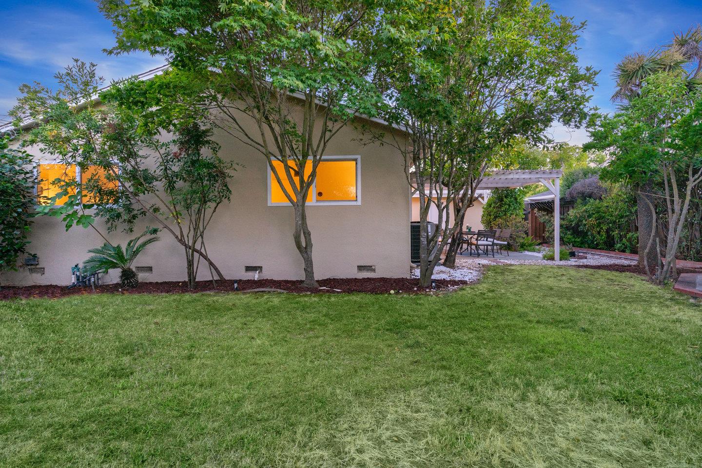 7457 Rollingdell Drive Cupertino, CA 95014 - Photo 29 of 33 a view of a backyard with a garden and trees