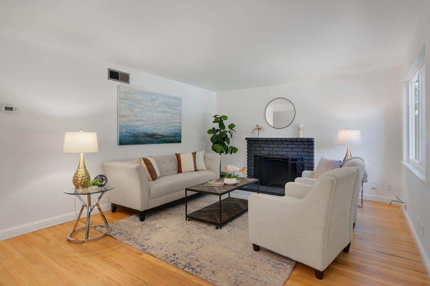 7457 Rollingdell Drive Cupertino, CA 95014 - Photo 8 of 33 a living room with furniture and a fireplace