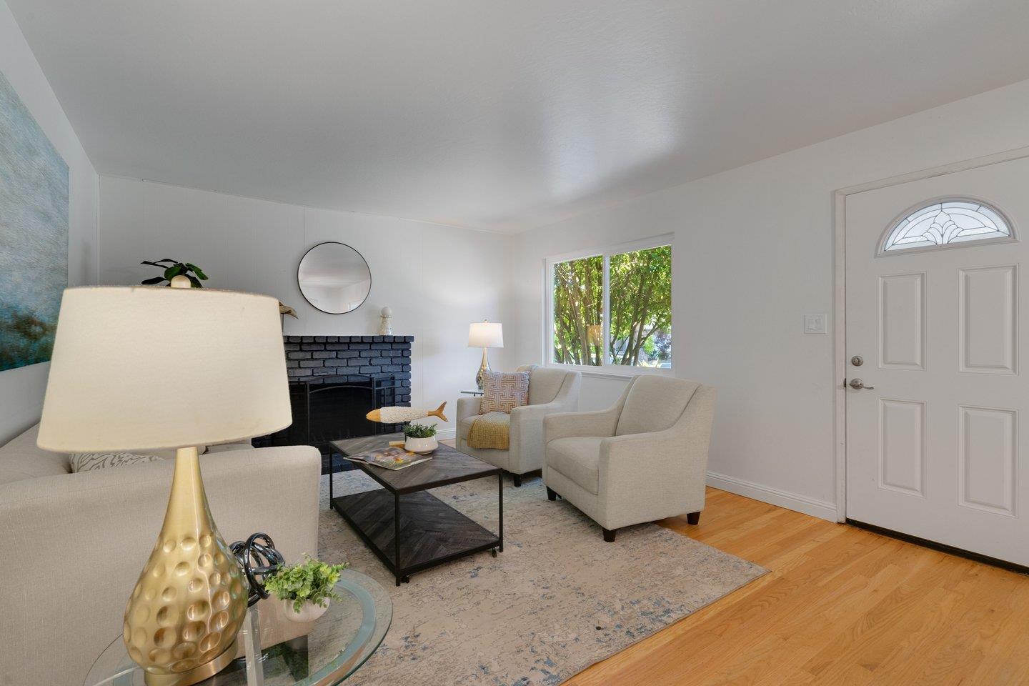 7457 Rollingdell Drive Cupertino, CA 95014 - Photo 9 of 33 a living room with furniture and a fireplace