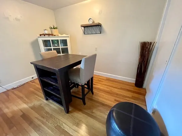 a view of a dining room with furniture and wooden floor