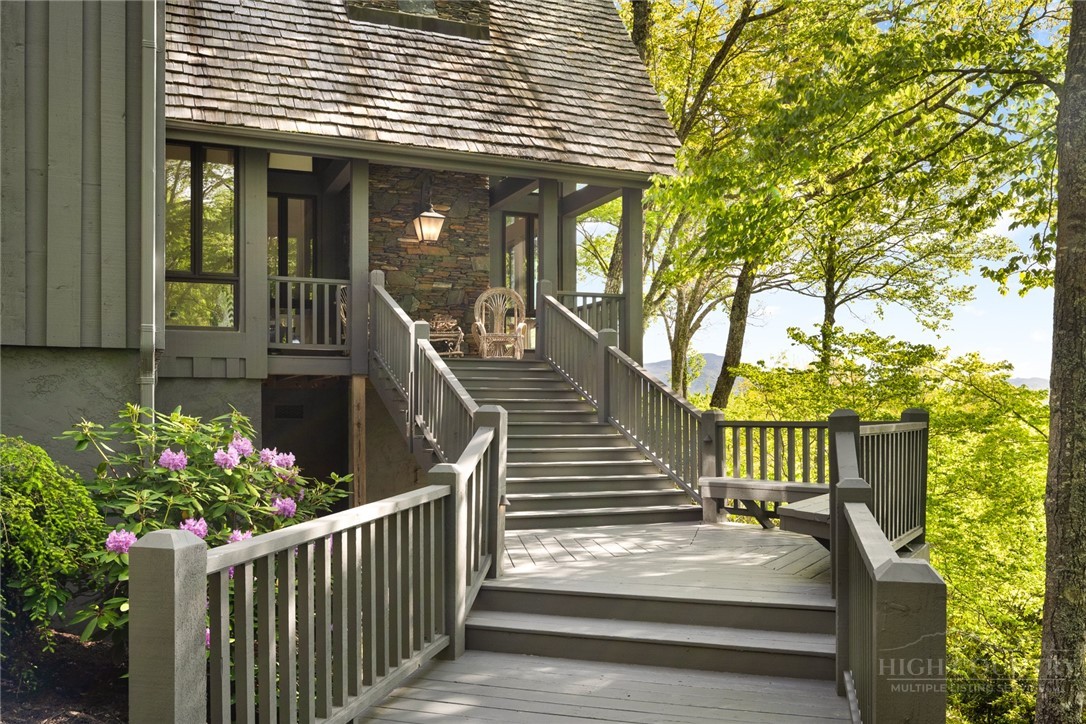 246 Mulberry Lane Boone, NC 28607 - Photo 2 of 49 a view of a house with wooden stairs and a table and chairs
