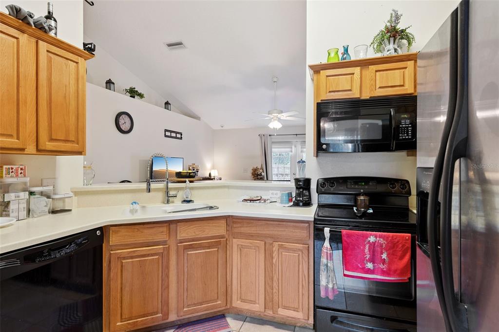 1308 Bates Avenue Eustis, FL 32726 - Photo 7 of 16 a kitchen with stainless steel appliances granite countertop a stove a sink and a microwave