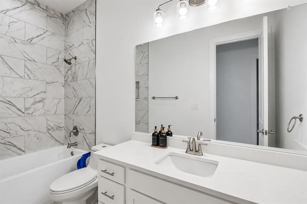 515 West Laureland Road Dallas, TX 75232 - Photo 15 of 32 a bathroom with a sink a toilet and shower