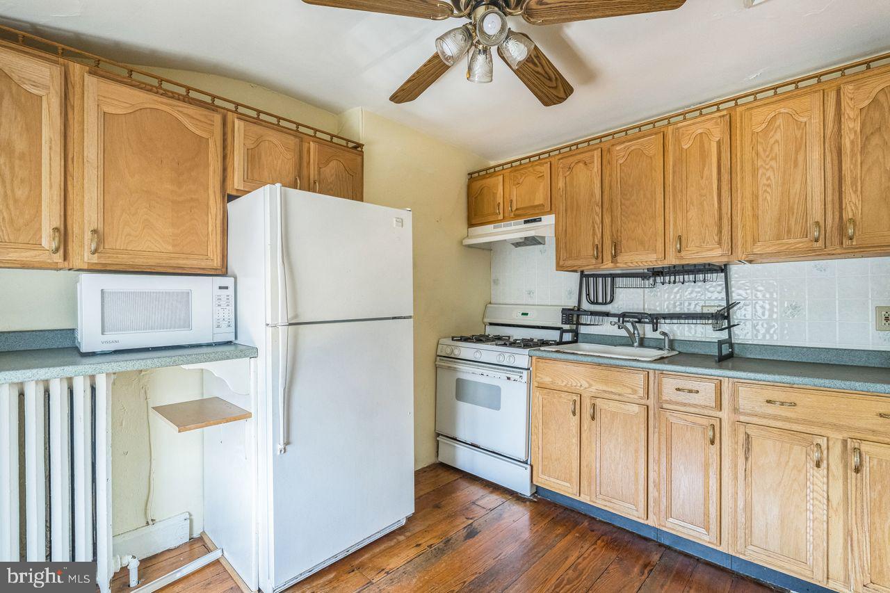 349 West State Street, Unit 3 Media, PA 19063 - Photo 6 of 8 a kitchen with stainless steel appliances granite countertop a refrigerator a microwave and cabinets