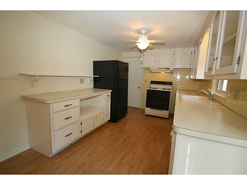 Kitchen. Lots of storage in this light kitchen and access to the garage through the door beyond.