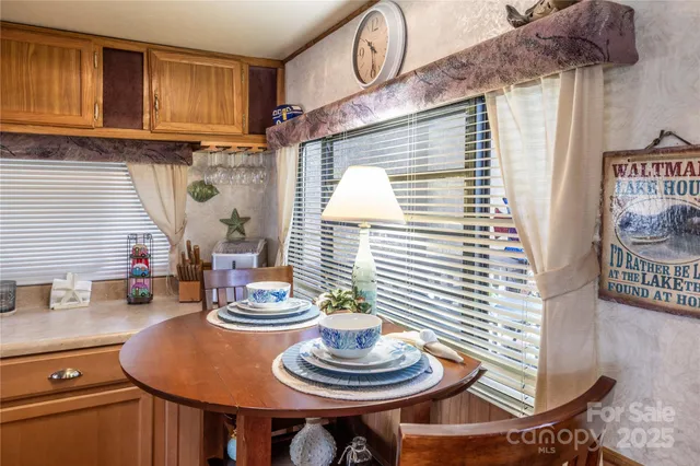 a view of a hallway and a livingroom with furniture