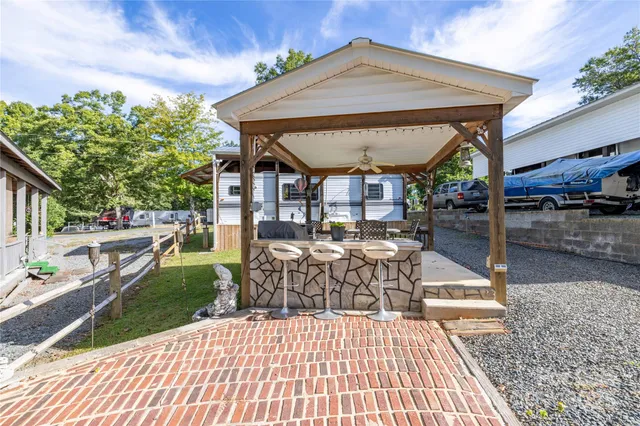 a patio with glass top table and chairs